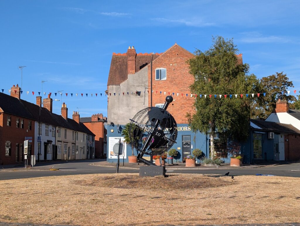 Close view of the Globe sculpture on the Globe Roundabout in Alcester on a sunny summer morning.
