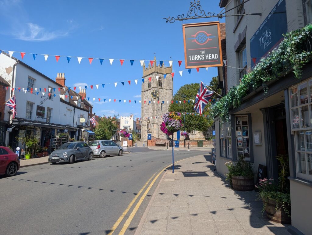 The Turks Head pub and its new sign on Alcester High Street, with St Nicholas Church in the background