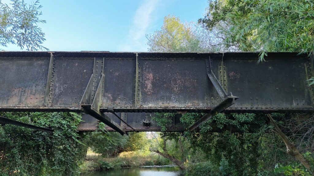Close-up of the riveted iron girders of Aston Cantlow railway bridge over the River Alne