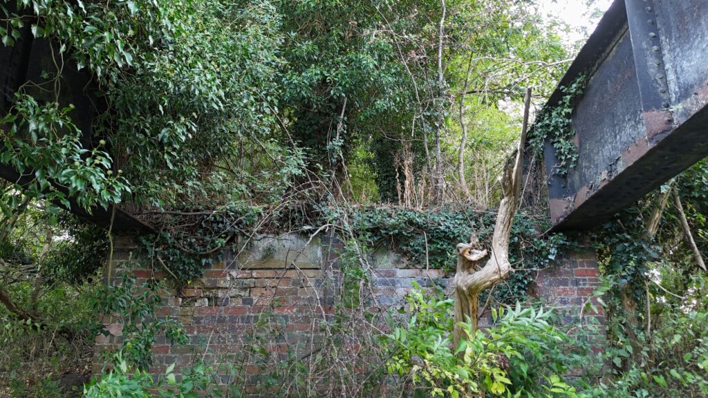 Close-up of the brick abutment and iron girder of Aston Cantlow railway bridge over the River Alne