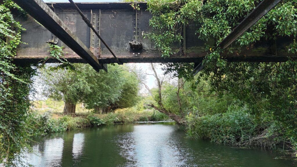 Underside of Aston Cantlow railway bridge showing iron girders above the River Alne